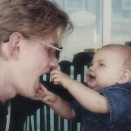 jon d is on the left with his daughter as a baby reaching out to for a hug