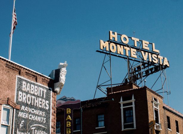 hotel monte vista's sign with the babbit brothers sign in downtown flagstaff